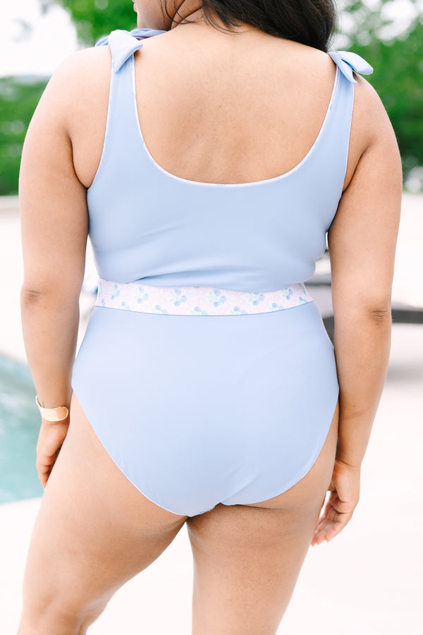Chic Soul Plus Size Clothing, a blue  one-piece swimsuit with bows at the top of the tank style sleeves and a contrast blue floral print belt with a golden clasp