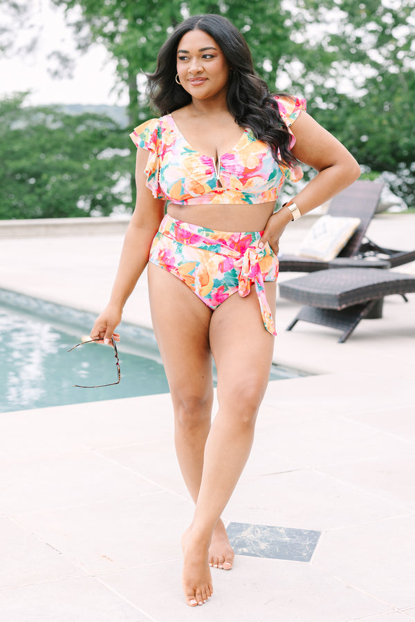 Chic Soul Plus Size Clothing, a pink, green, orange, and white water color floral print swim top with a gold V detail at center bust and ruffle sleeves