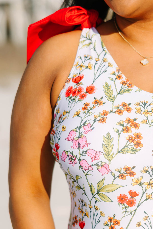 Chic Soul plus size clothing, white floral one piece with a one shoulder strap on the left side that has a red bow on top of the shoulder 