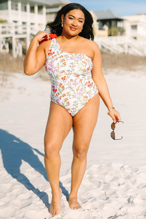 Chic Soul plus size clothing, white floral one piece with a one shoulder strap on the left side that has a red bow on top of the shoulder 