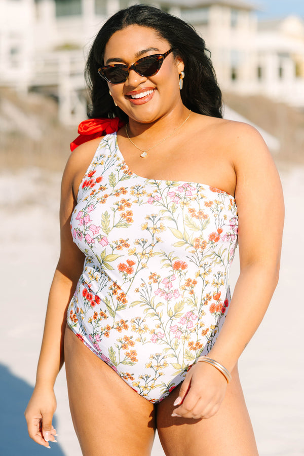 Chic Soul plus size clothing, white floral one piece with a one shoulder strap on the left side that has a red bow on top of the shoulder 