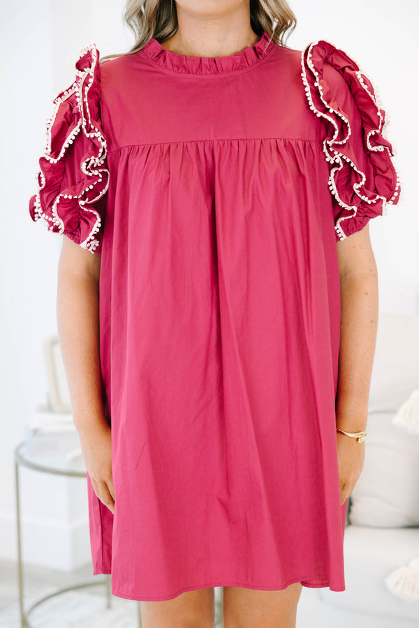 Plus size red flowy mini dress with ruffled pom-pom sleeves and a high neckline.
