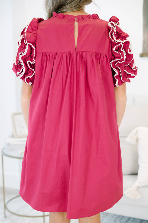 Plus size red flowy mini dress with ruffled pom-pom sleeves and a high neckline.