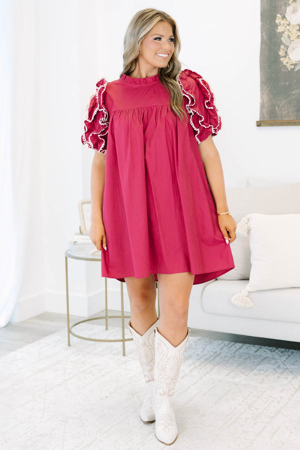 Plus size red flowy mini dress with ruffled pom-pom sleeves and a high neckline.