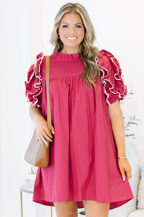 Plus size red flowy mini dress with ruffled pom-pom sleeves and a high neckline.
