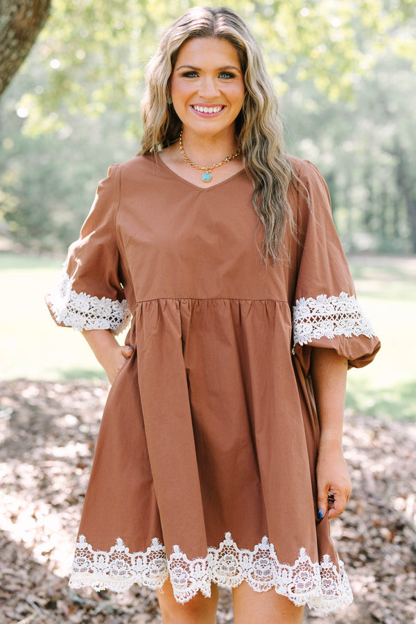 Plus size brown babydoll mini dress with puff sleeves and white crochet lace trim on hem and cuffs.