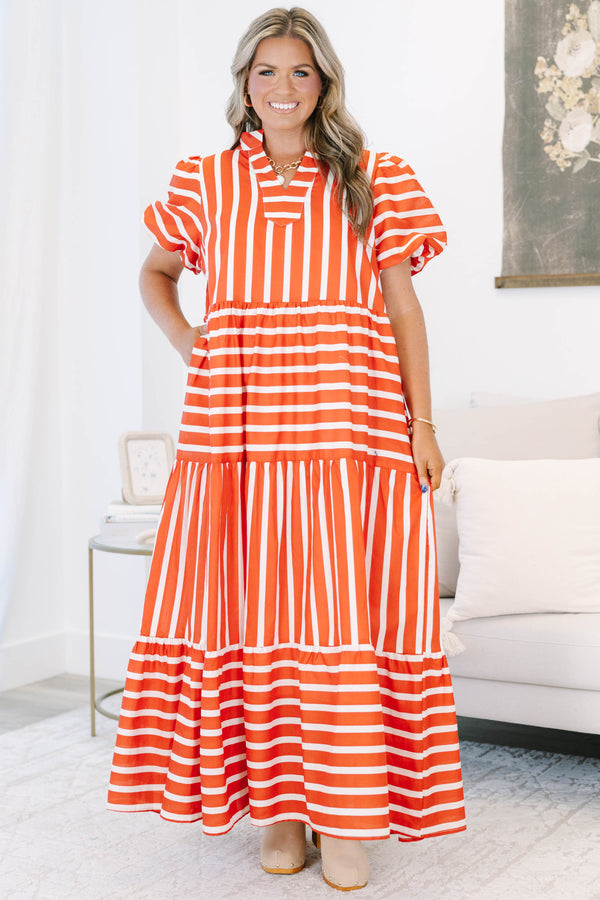 Plus size orange and white striped tiered maxi dress with puff sleeves and a flowy fit.