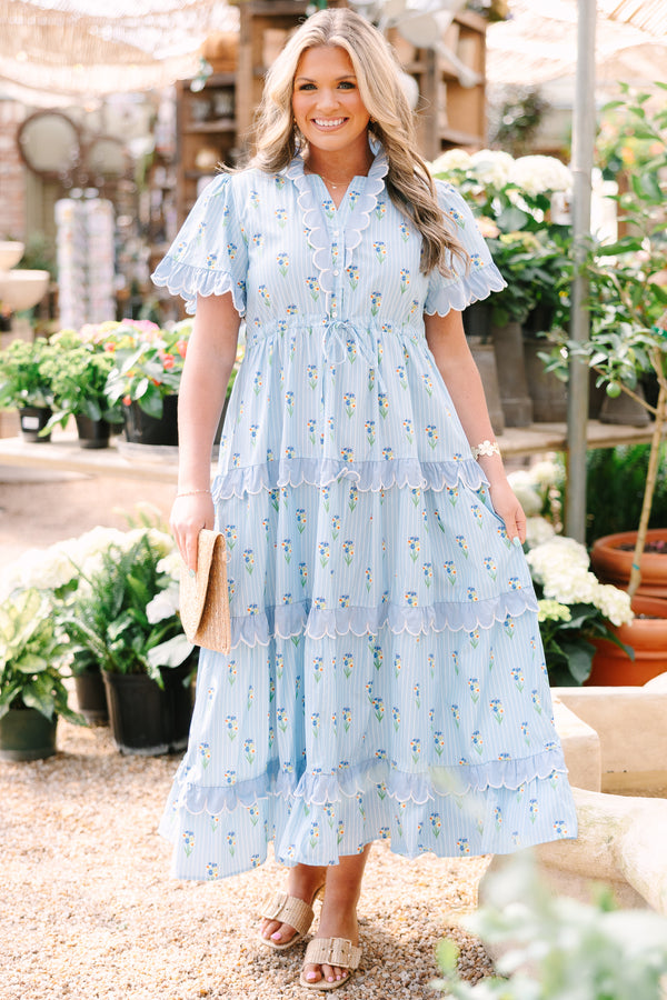 Chic Soul plus size clothing, blue maxi  dress with a floral pattern and scalloped ruffle detailing on the ends of the sleeves going down the v-neckline and on each tier of the dress as well as a bow that ties under the chest area 