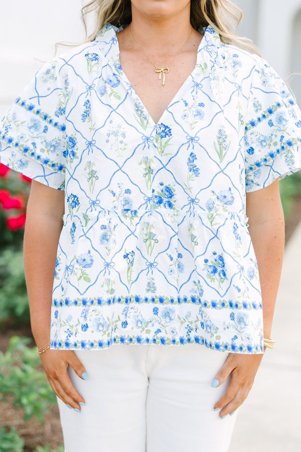 Chic Soul plus size clothing, white top with short sleeves that have a ruffle flare on the ends of the sleeves as well as a slight v-neckline and a blue and green block pattern throughout