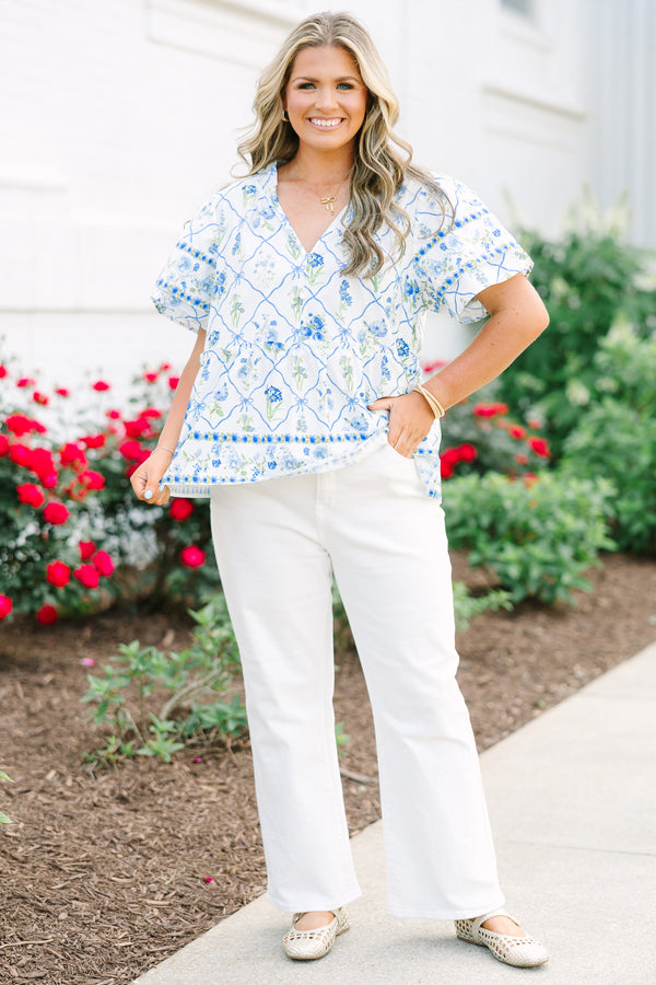 Chic Soul plus size clothing, white top with short sleeves that have a ruffle flare on the ends of the sleeves as well as a slight v-neckline and a blue and green block pattern throughout