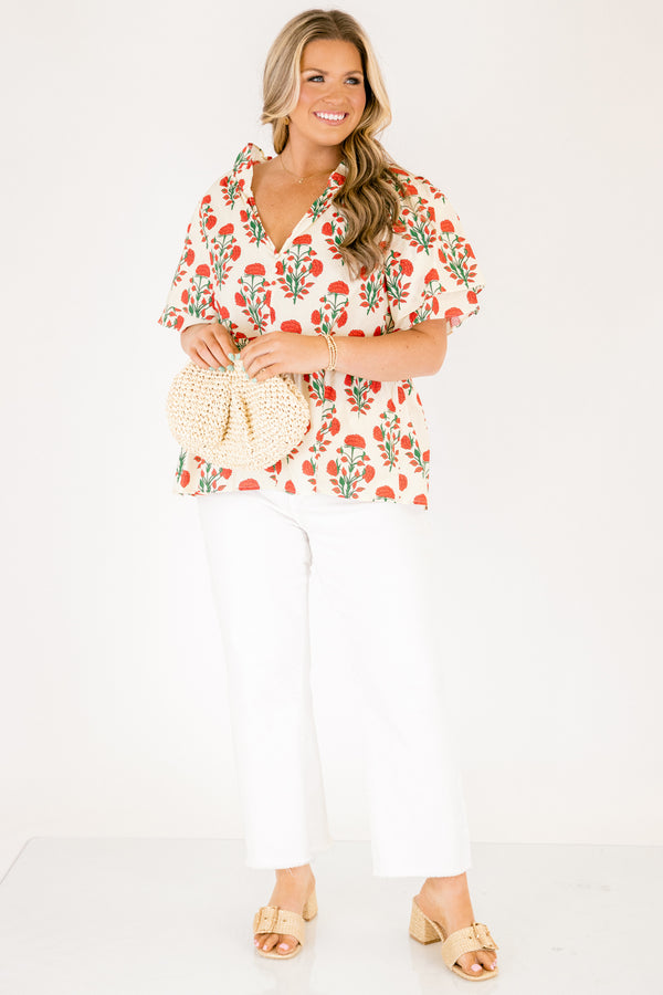 Chic Soul plus size clothing, white top with short sleeves that have a ruffle flare on the ends of the sleeves as well as a slight v-neckline and an abstract orange and green block pattern throughout
