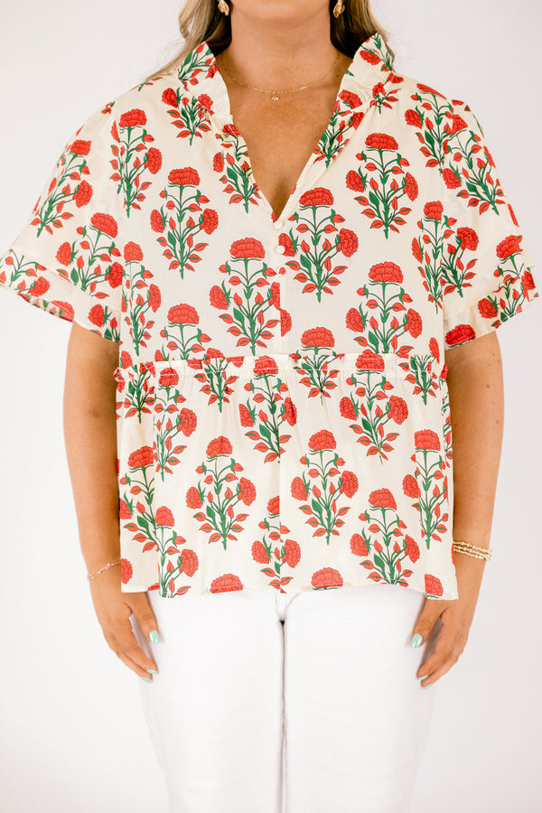 Chic Soul plus size clothing, white top with short sleeves that have a ruffle flare on the ends of the sleeves as well as a slight v-neckline and an abstract orange and green block pattern throughout