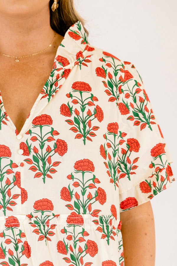 Chic Soul plus size clothing, white top with short sleeves that have a ruffle flare on the ends of the sleeves as well as a slight v-neckline and an abstract orange and green block pattern throughout