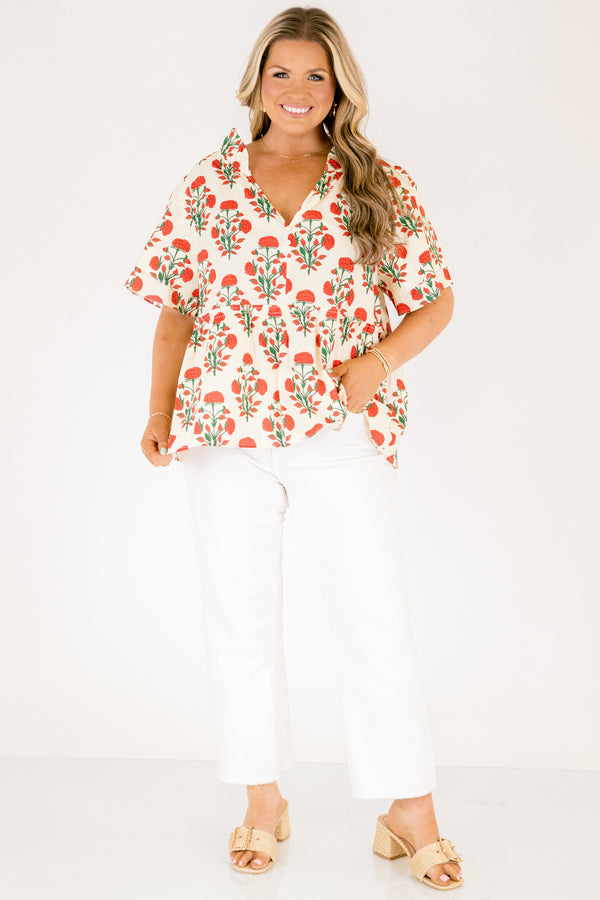 Chic Soul plus size clothing, white top with short sleeves that have a ruffle flare on the ends of the sleeves as well as a slight v-neckline and an abstract orange and green block pattern throughout