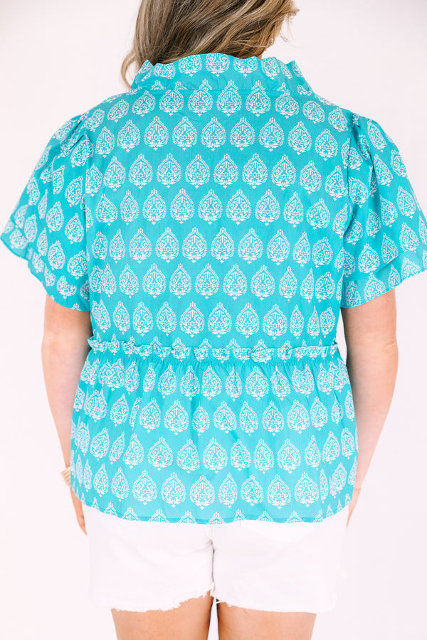 Chic Soul plus size clothing, teal top with short sleeves that have a ruffle flare on the ends of the sleeves as well as a slight v-neckline and an abstract white block pattern throughout 

