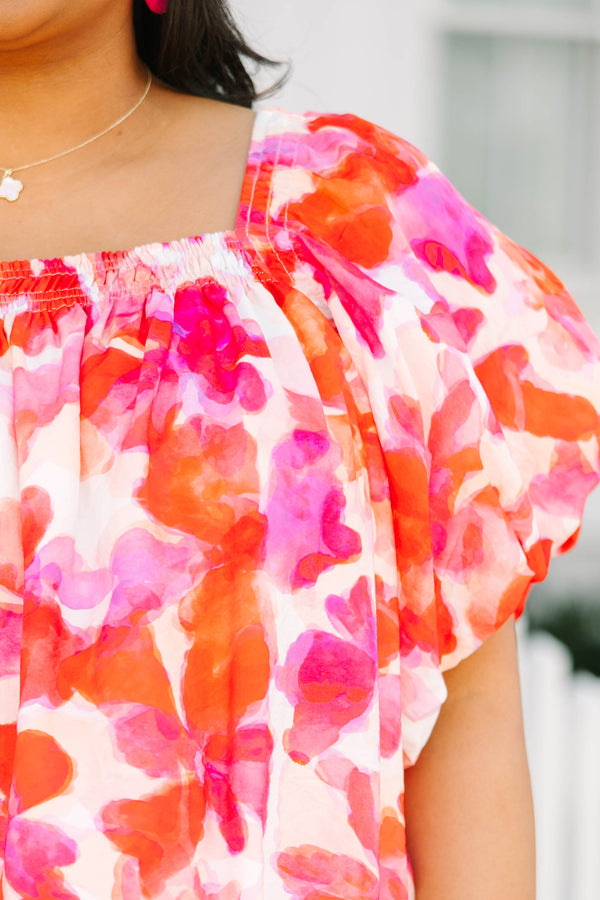 Chic Soul plus size clothing, white top with bubble sleeves a square neckline and a pink and orange and red watercolor floral pattern throughout