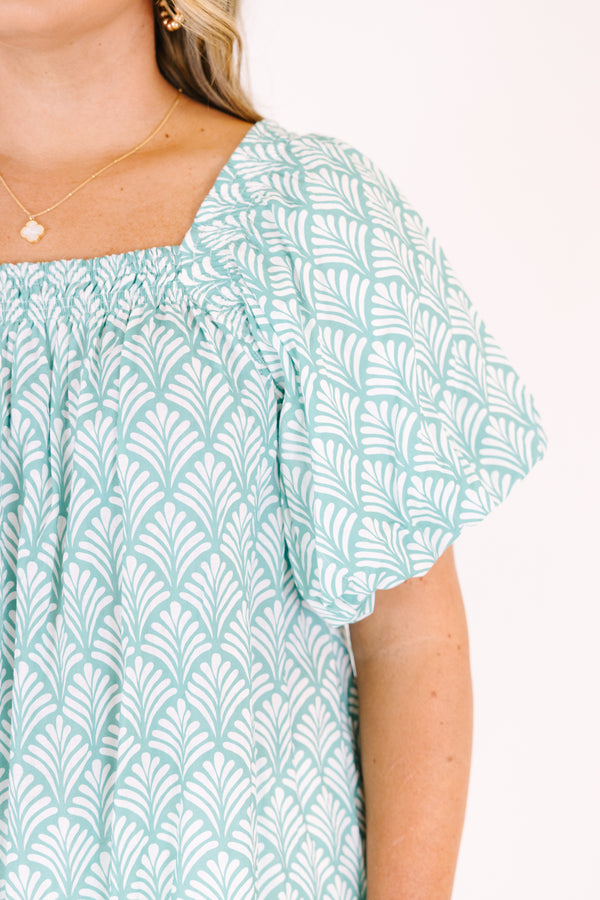 Chic Soul plus size clothing, turquoise baby doll top with bubble sleeves a square neckline and a floral block pattern throughout  