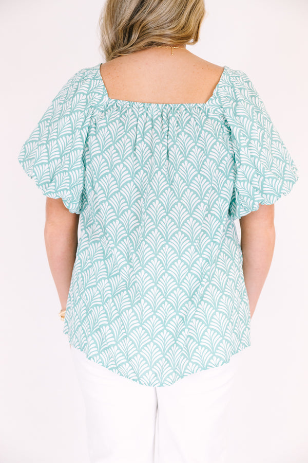 Chic Soul plus size clothing, turquoise baby doll top with bubble sleeves a square neckline and a floral block pattern throughout  