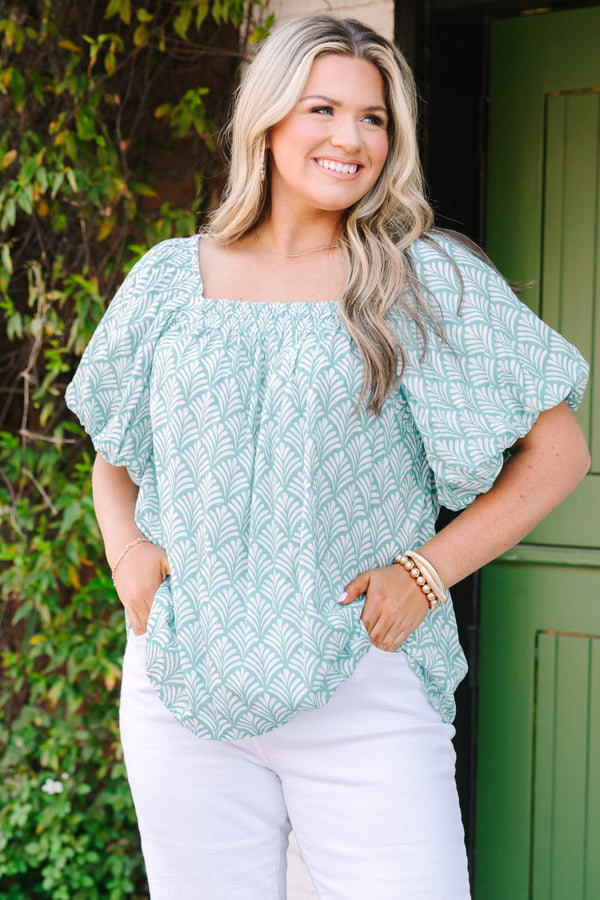 Chic Soul plus size clothing, turquoise baby doll top with bubble sleeves a square neckline and a floral block pattern throughout  