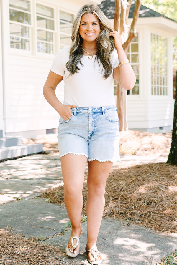 Chic Soul plus size clothing, light wash denim shorts with scalloped hemline and daisy appliques along hem