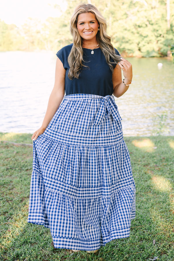 Plus size clothing, short sleeve tiered maxi dress with  a navy bodice and the skirt a navy blue and white gingham with a self-tie waist belt