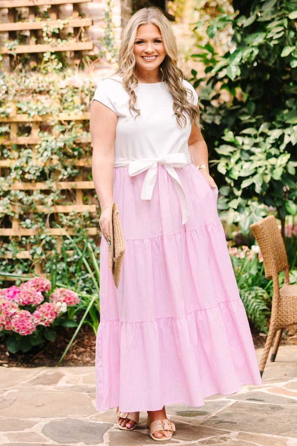 Plus Size maxi dress with a white short-sleeve bodice and a tiered pink striped skirt with a bow.