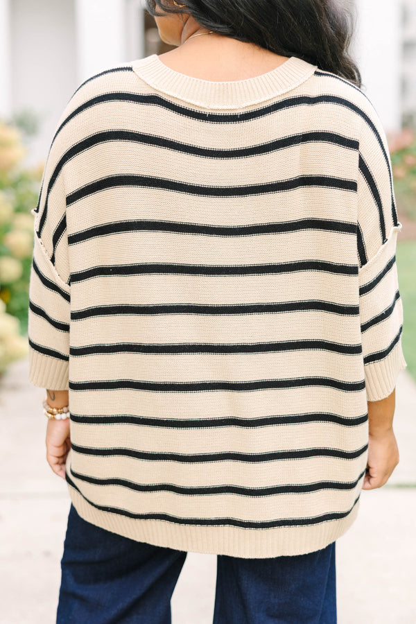 taupe sweater with drop shoulders and black stripes with exposed seam details