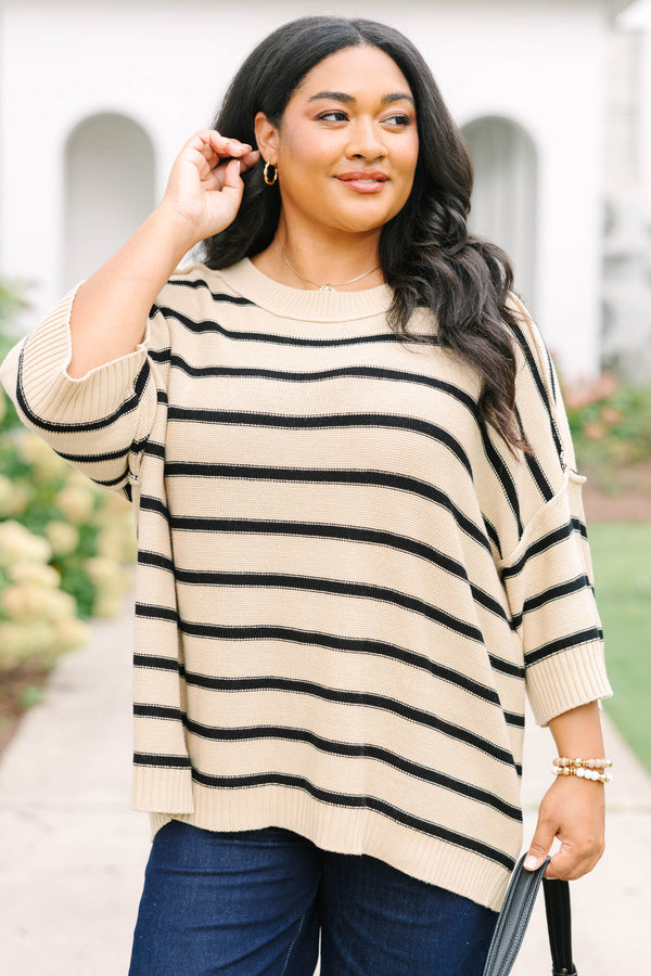 taupe sweater with drop shoulders and black stripes with exposed seam details
