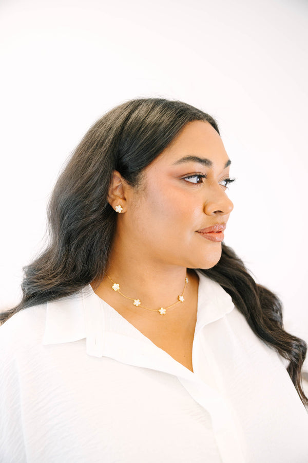 Plus Size gold-toned necklace and earring set featuring delicate cream-colored floral charms.