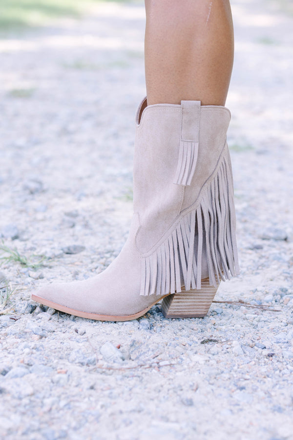 Plus Size beige suede pointed-toe ankle boots with long fringe detailing and a stacked heel.