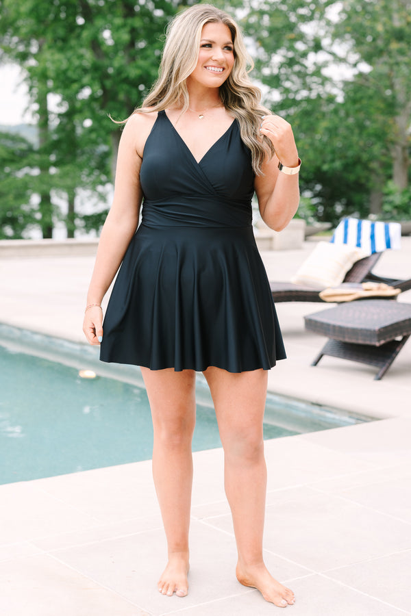 Black Swim Dress with a flowy skirt, wrap-style bodice, and adjustable straps.