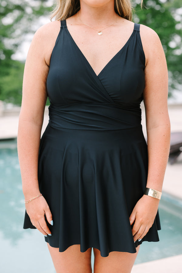 Black Swim Dress with a flowy skirt, wrap-style bodice, and adjustable straps.