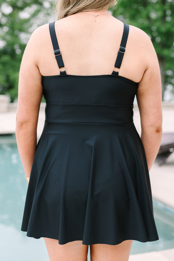 Black Swim Dress with a flowy skirt, wrap-style bodice, and adjustable straps.