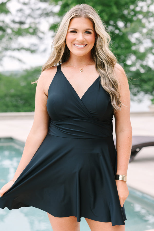 Black Swim Dress with a flowy skirt, wrap-style bodice, and adjustable straps.