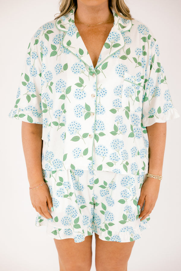 Plus Size short-sleeve pajama set with blue hydrangea print, ruffle trim, and button-down front.