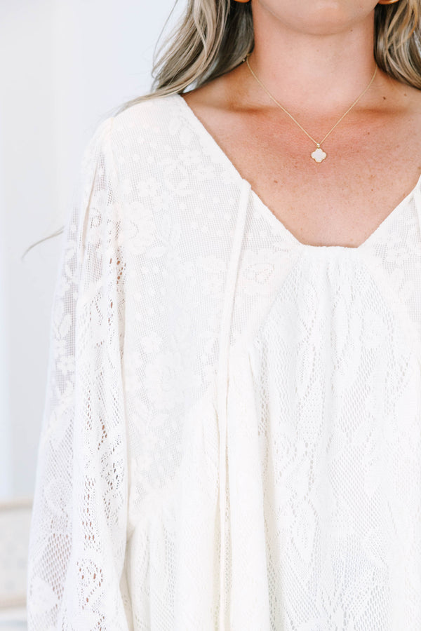 Plus Size cream lace top with long balloon sleeves, a V-neckline, and tie details.