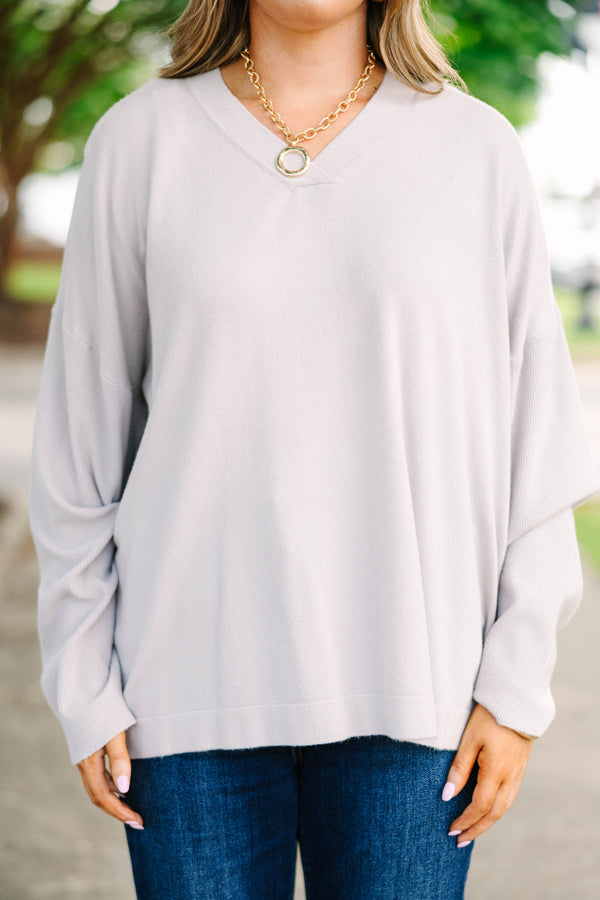 Plus size taupe-gray V-neck sweater with a relaxed, flowy fit and soft, stretchy fabric.