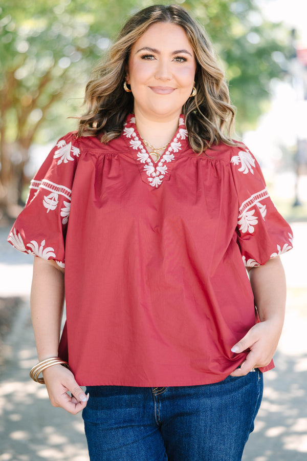 Plus size crimson cotton top with white embroidery, V-neckline, and flowy puff sleeves.