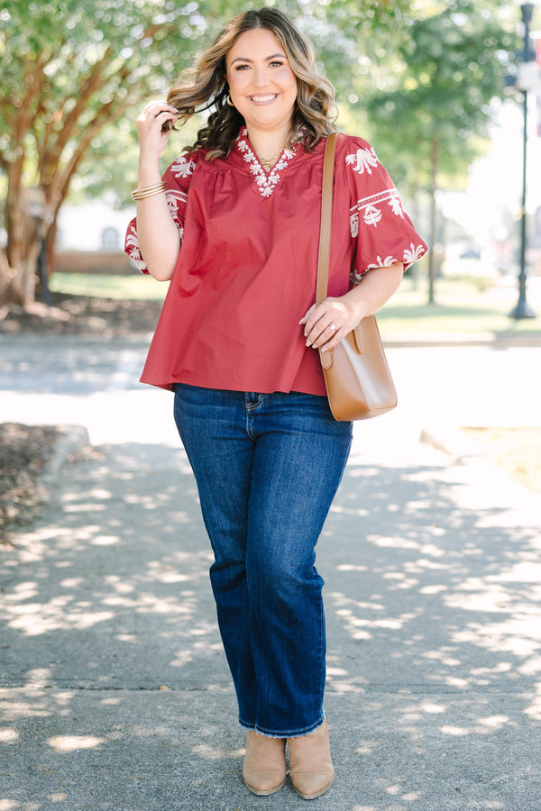Plus size crimson cotton top with white embroidery, V-neckline, and flowy puff sleeves.