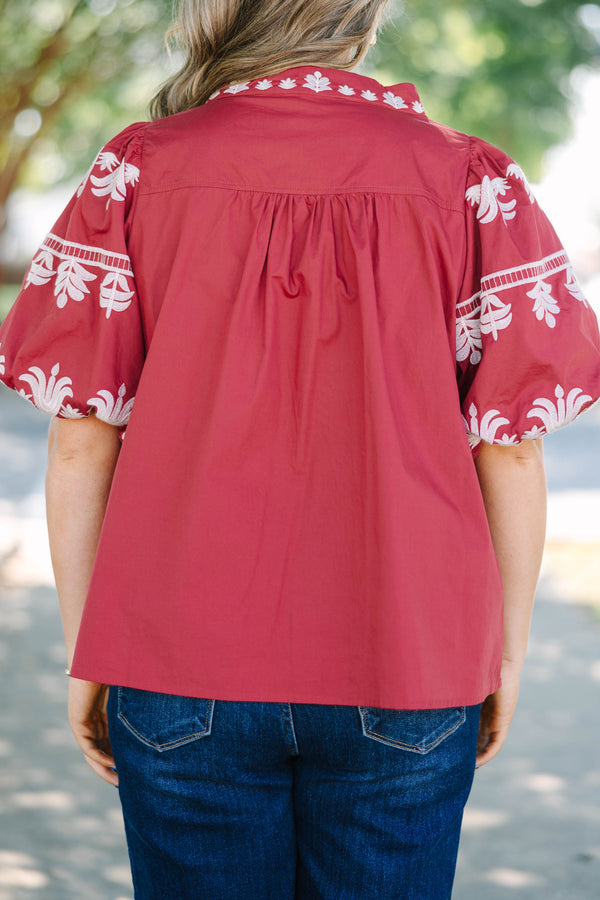 Plus size crimson cotton top with white embroidery, V-neckline, and flowy puff sleeves.