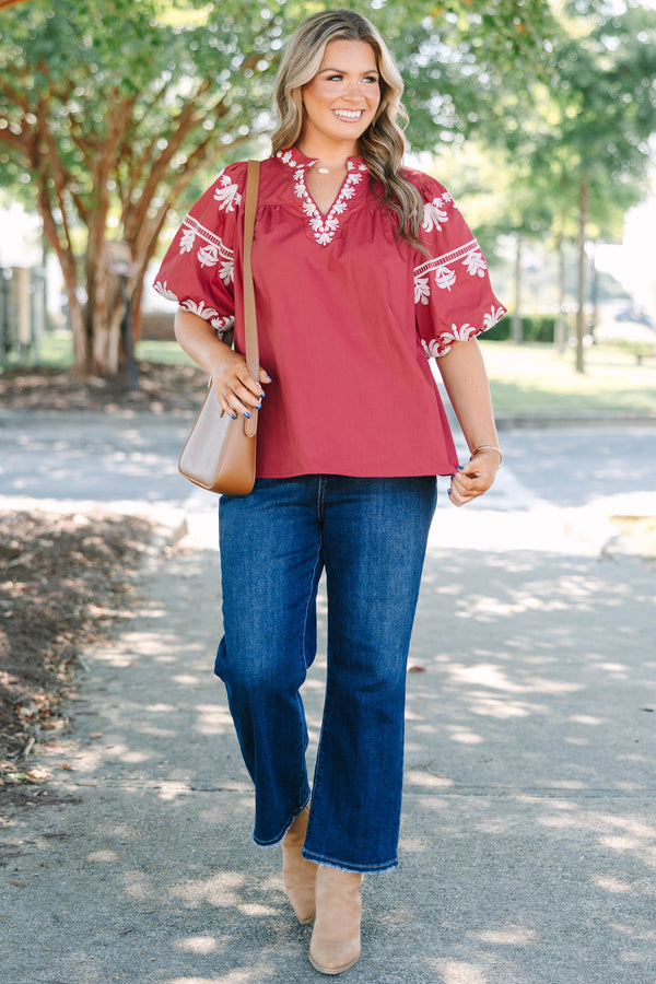 Plus size crimson cotton top with white embroidery, V-neckline, and flowy puff sleeves.