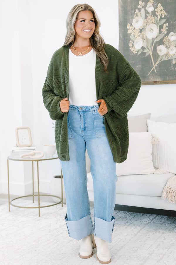 Plus size light wash high-rise wide-leg jeans featuring oversized cuffed hems and patch pockets.