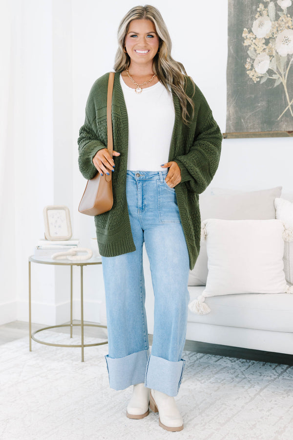 Plus size light wash high-rise wide-leg jeans featuring oversized cuffed hems and patch pockets.