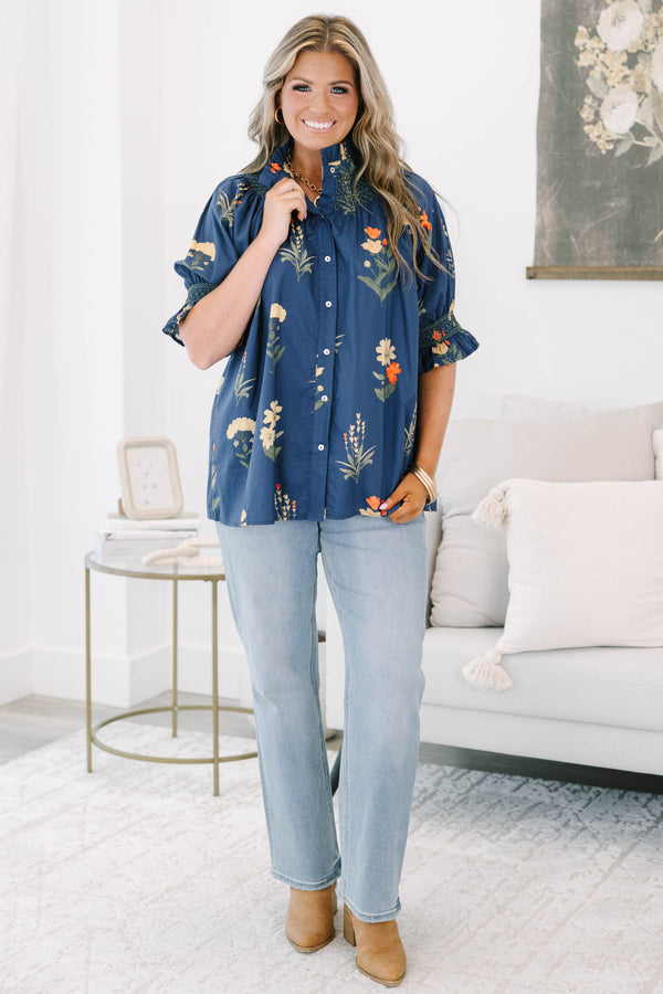 Plus size navy floral cotton top with smocked high neck, button front, and flowy puff sleeves.