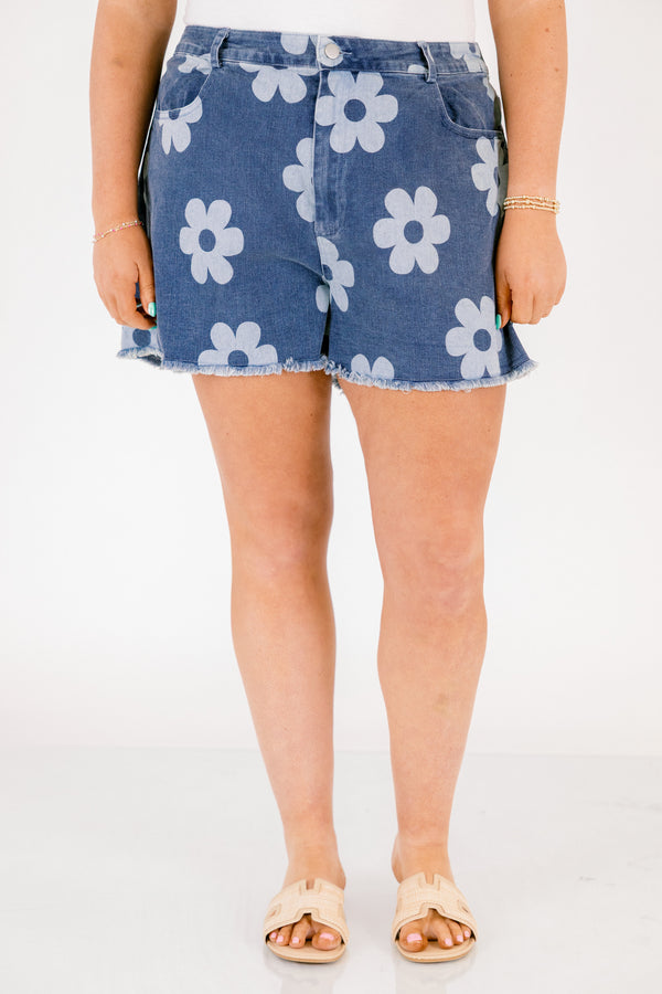 Chic Soul plus size clothing, dark denim shorts with front pockets and fringe details at the end of the shorts and a light blue floral pattern throughout