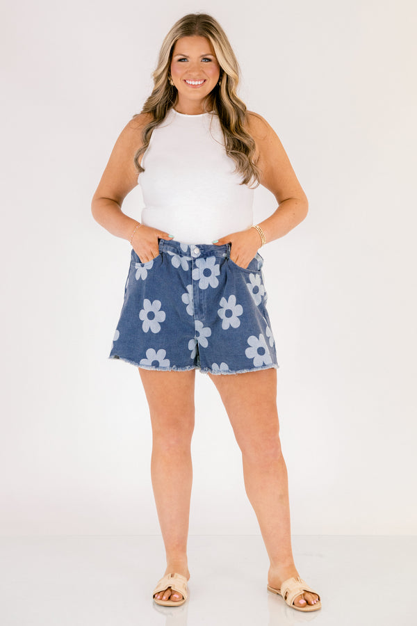 Chic Soul plus size clothing, dark denim shorts with front pockets and fringe details at the end of the shorts and a light blue floral pattern throughout