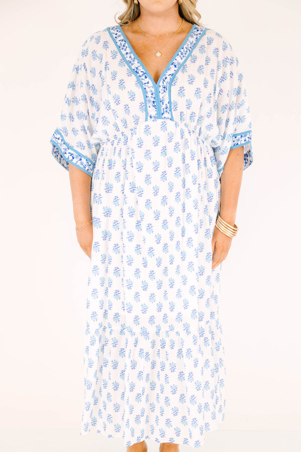 Chic Soul plus size clothing, cerulean blue maxi dress with short sleeves that have a floral pattern cuffed as well as a floral pattern outlining the v-neckline and a floral block pattern throughout