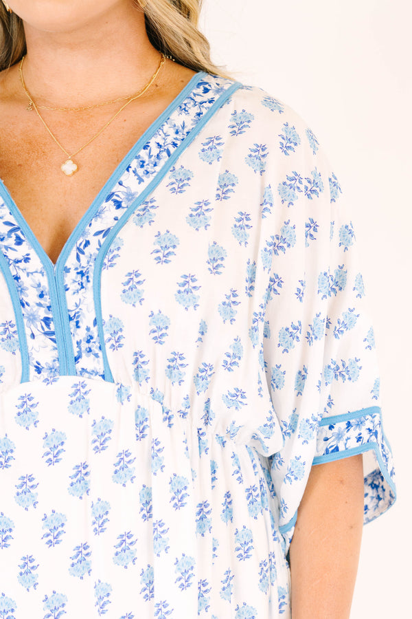 Chic Soul plus size clothing, cerulean blue maxi dress with short sleeves that have a floral pattern cuffed as well as a floral pattern outlining the v-neckline and a floral block pattern throughout