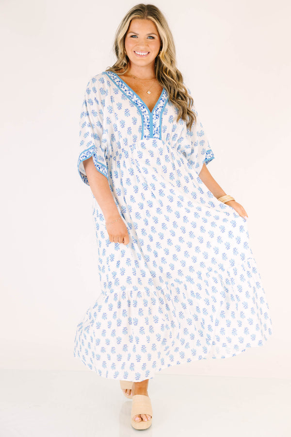 Chic Soul plus size clothing, cerulean blue maxi dress with short sleeves that have a floral pattern cuffed as well as a floral pattern outlining the v-neckline and a floral block pattern throughout