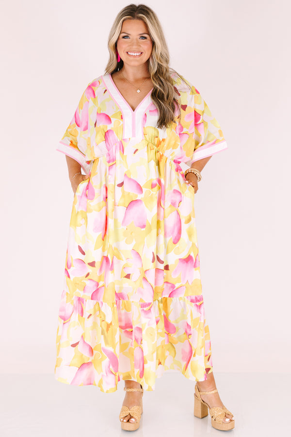 Chic Soul plus size clothing, white maxi dress with half sleeves and a yellow and fuchsia floral pattern throughout as well as pink outlining the v-neckline and end of the sleeves 